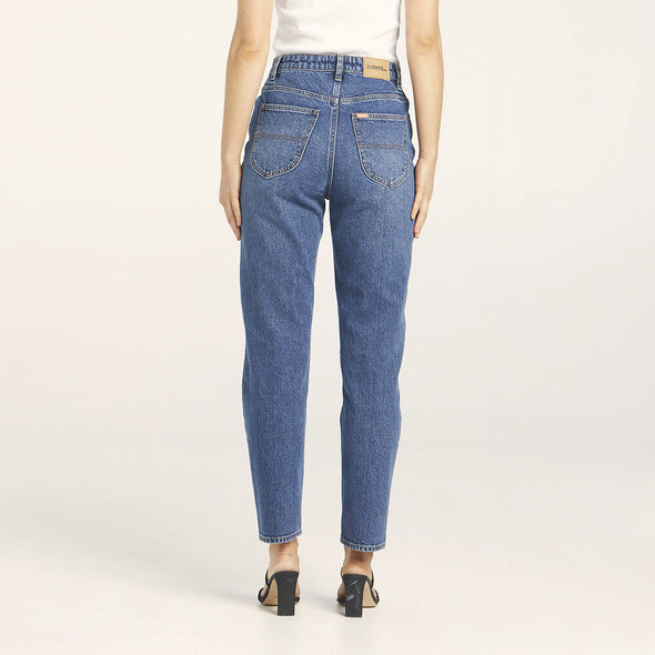 Our best selling Hi Mom sits super high on the waist, with a slim leg that tapers to the hem. The rolled cuff keeps it versatile allowing you to tailor the jean to your own length. Designed to be worn fitted, this jean will soften and shape to the body with wear for an effortless fit. Made in a darker blue, vintage indigo wash with the look of a vintage jean but the added comfort of stretch.