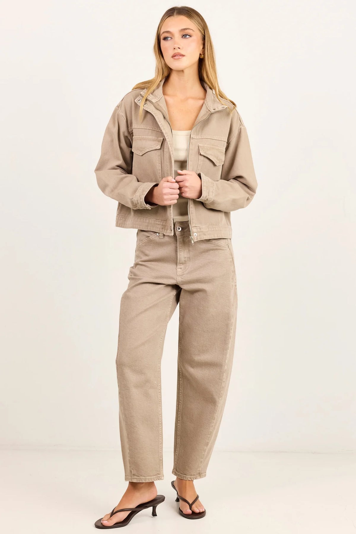 - Funnel neckline
- Front patch pockets
- Button front closure
- Plain taupe denim design
- Structured cotton feel
- Fabric Composition - 100% Cotton