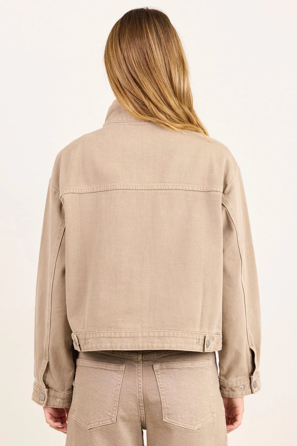 - Funnel neckline
- Front patch pockets
- Button front closure
- Plain taupe denim design
- Structured cotton feel
- Fabric Composition - 100% Cotton