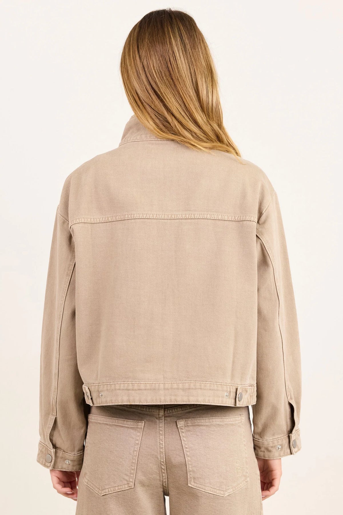- Funnel neckline
- Front patch pockets
- Button front closure
- Plain taupe denim design
- Structured cotton feel
- Fabric Composition - 100% Cotton