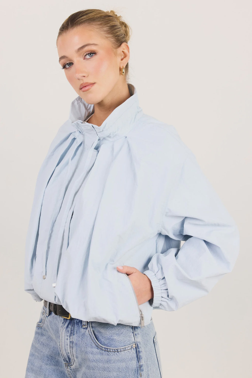 - High funnel neckline
- Long sleeves with elasticated cuffs
- Concealed zip-front fastening
- Adjustable neckline ties
- Relaxed oversized fit
- Elasticated hem
- Side pockets
- Fabric Composition - 100% Nylon
