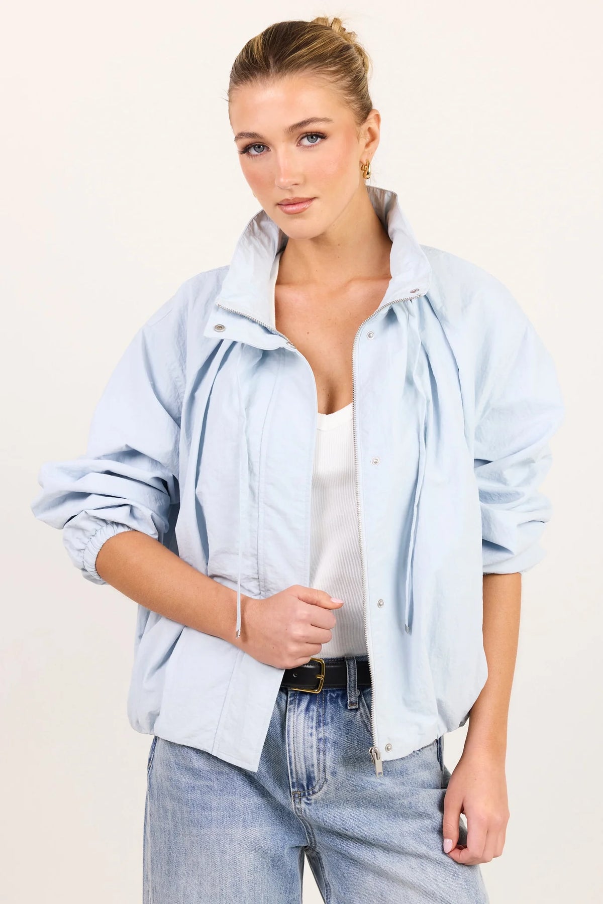 - High funnel neckline
- Long sleeves with elasticated cuffs
- Concealed zip-front fastening
- Adjustable neckline ties
- Relaxed oversized fit
- Elasticated hem
- Side pockets
- Fabric Composition - 100% Nylon