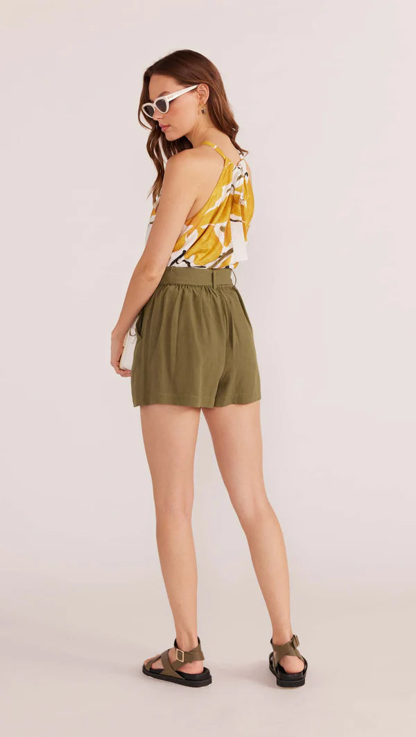 The Amara Belted Short is a wardrobe classic you can wear on repeat with no one noticing. Comfort meets style with these classic shorts, the relaxed fit and adjustable waist tie making it super easy for you to go about your busy day without the feeling of being restrained. Style with our Zuri Halter Neck Cami tucked in or out with strappy sandals to complete the look.


- Linen blend
- Mini length
- Pockets
- Hook and eye closure with zip
- Self tie waist band
- Can be worn high waisted or low rise
- Lined
