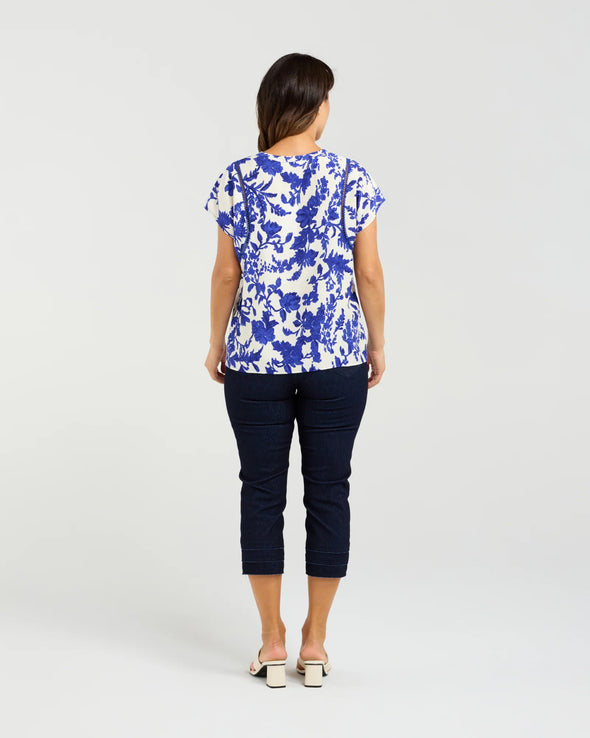 Short sleeve blouse in a bold cobalt floral print

Feminine lace trim accents on the sleeves

Relaxed, easy-to-wear fit with flattering drape

Lightweight 80% Viscose, 20% Nylon blend

A versatile piece for day-to-night styling