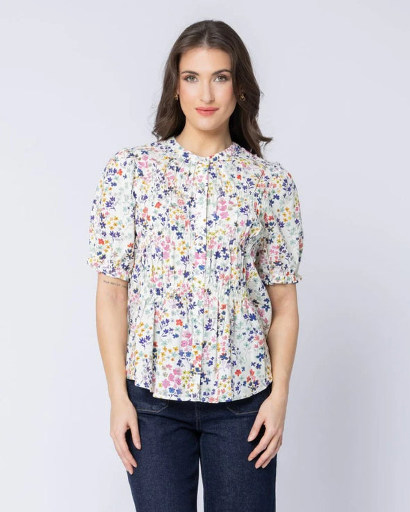 Classic button-front design

Shirred panels across the body for added texture

Crew neckline for a timeless finish

Elasticated ruffle cuffs on elbow-length sleeves

All-over pattern for a feminine touch

Made from 100% breathable cotton

Standard fit, no stretch other than in shirring