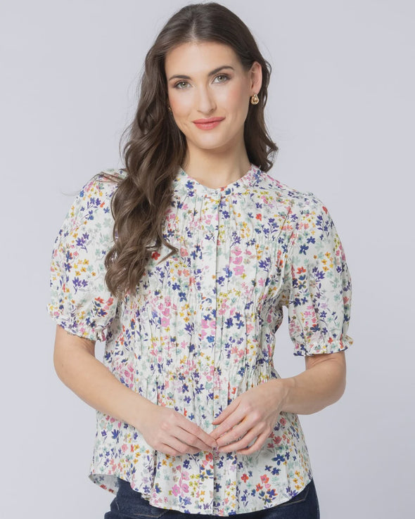 Classic button-front design

Shirred panels across the body for added texture

Crew neckline for a timeless finish

Elasticated ruffle cuffs on elbow-length sleeves

All-over pattern for a feminine touch

Made from 100% breathable cotton

Standard fit, no stretch other than in shirring