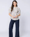 Classic button-front design

Shirred panels across the body for added texture

Crew neckline for a timeless finish

Elasticated ruffle cuffs on elbow-length sleeves

All-over pattern for a feminine touch

Made from 100% breathable cotton

Standard fit, no stretch other than in shirring