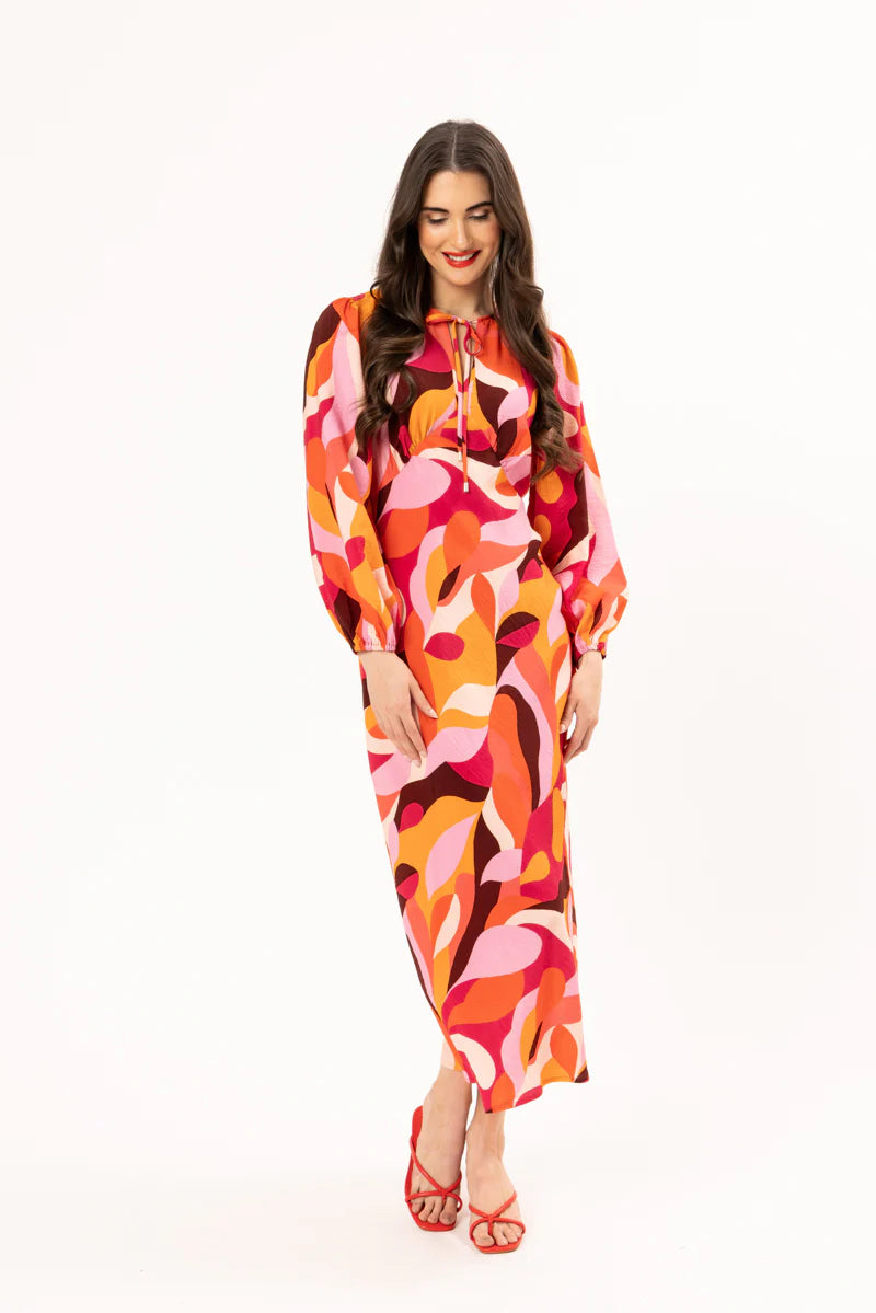 Elevate your wardrobe with our stunning long-sleeved maxi dress, crafted from a fun bright patterned fabric that effortlessly blends style and comfort. Featuring a flattering round neck with a v-neck detail and tie, this dress showcases a shaped empire bust for a feminine silhouette. The elastic cuff detail adds a touch of sophistication, while the convenient back neck zip ensures easy wear.