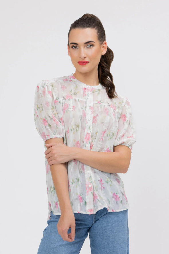 95% Polyester, 5% Spandex

Sheer floral blouse in soft pink Crinkle Blossom print

Delicate pleat detailing for added texture

Puffed short sleeves with a feminine silhouette

Lightweight and versatile for layering or wearing alone