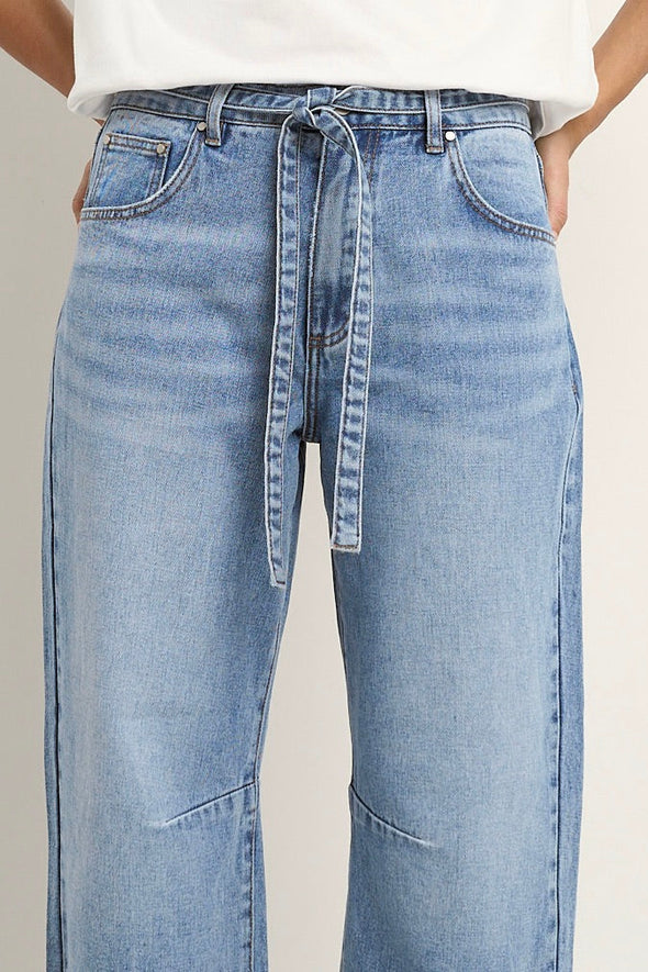 100% Cotton denim

High-rise fit for a flattering waistline

Barrel-leg cut for a relaxed, on-trend look

Soft light blue wash for everyday versatility

Self-tie waist belt for added shape and styling