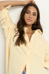 Oversized button-down shirt in pastel lemon

Lightweight cotton with a soft, crisp finish

Classic collared neckline with chest pocket

Wide cuffs and curved hem for a flattering shape

100% Cotton – breathable and easy to style

Wear tucked, tied, layered, or solo for versatile looks