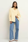 Oversized button-down shirt in pastel lemon

Lightweight cotton with a soft, crisp finish

Classic collared neckline with chest pocket

Wide cuffs and curved hem for a flattering shape

100% Cotton – breathable and easy to style

Wear tucked, tied, layered, or solo for versatile looks