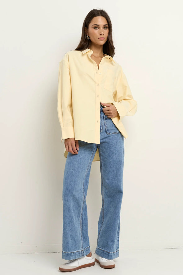 Oversized button-down shirt in pastel lemon

Lightweight cotton with a soft, crisp finish

Classic collared neckline with chest pocket

Wide cuffs and curved hem for a flattering shape

100% Cotton – breathable and easy to style

Wear tucked, tied, layered, or solo for versatile looks