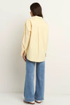Oversized button-down shirt in pastel lemon

Lightweight cotton with a soft, crisp finish

Classic collared neckline with chest pocket

Wide cuffs and curved hem for a flattering shape

100% Cotton – breathable and easy to style

Wear tucked, tied, layered, or solo for versatile looks