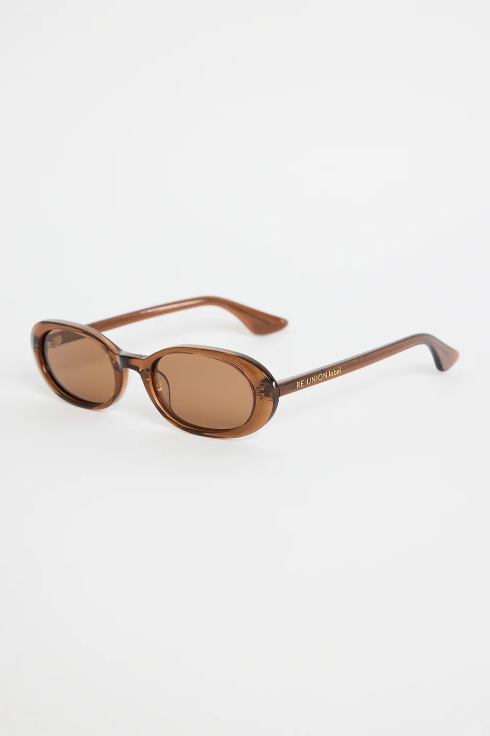 The Sydney Espresso Narrow Oval Sunglasses bring a sleek, retro-inspired touch to your everyday style. Designed in a warm espresso tone, this slim oval frame feels effortlessly cool with its lightweight, glossy finish. The soft brown lenses keep things understated and chic, making this pair an easy match for everything in your wardrobe.

A timeless, wear-anywhere accessory that adds instant polish.

- Recycled Acetate

- UV Protection Category 3