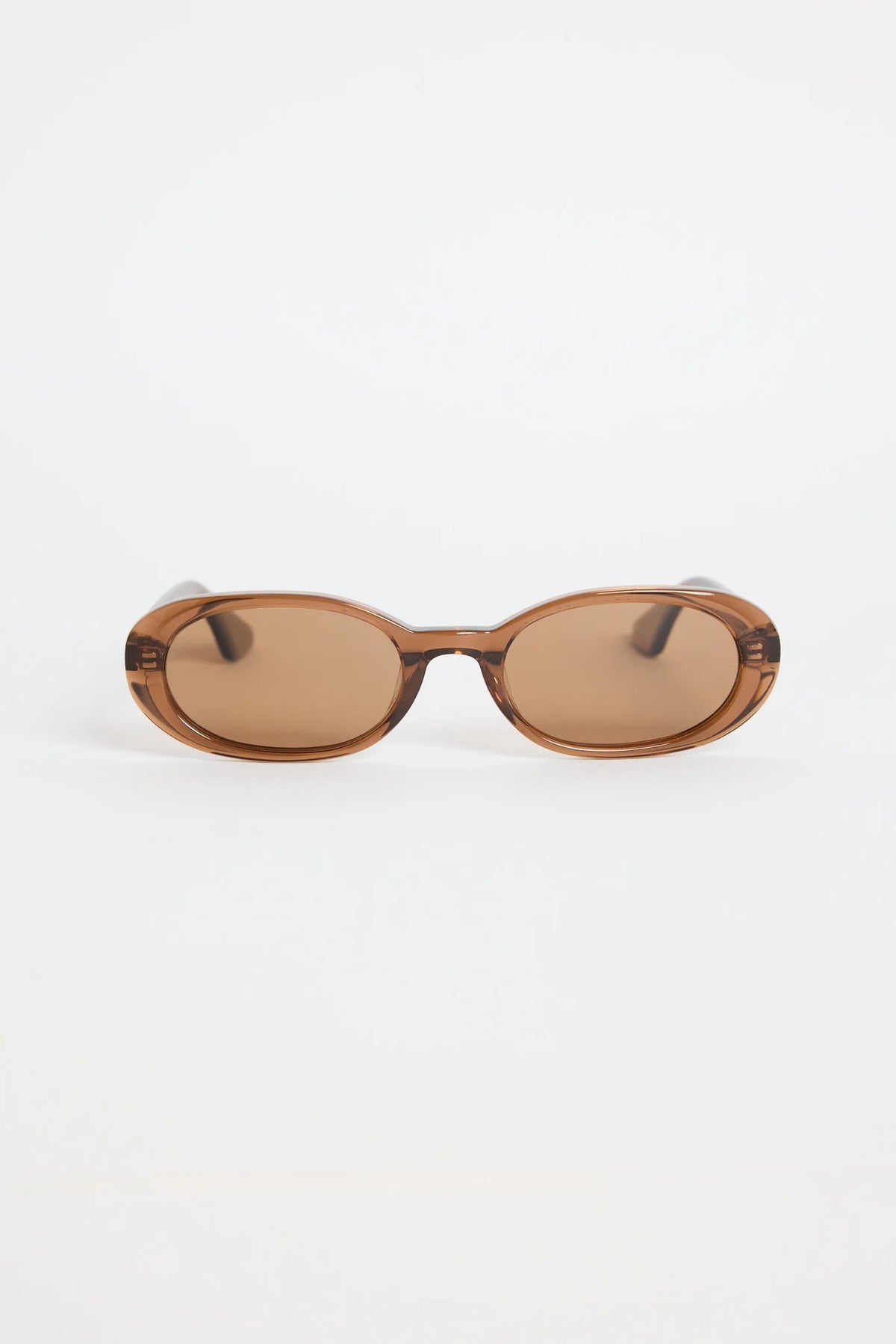 The Sydney Espresso Narrow Oval Sunglasses bring a sleek, retro-inspired touch to your everyday style. Designed in a warm espresso tone, this slim oval frame feels effortlessly cool with its lightweight, glossy finish. The soft brown lenses keep things understated and chic, making this pair an easy match for everything in your wardrobe.

A timeless, wear-anywhere accessory that adds instant polish.

- Recycled Acetate

- UV Protection Category 3
