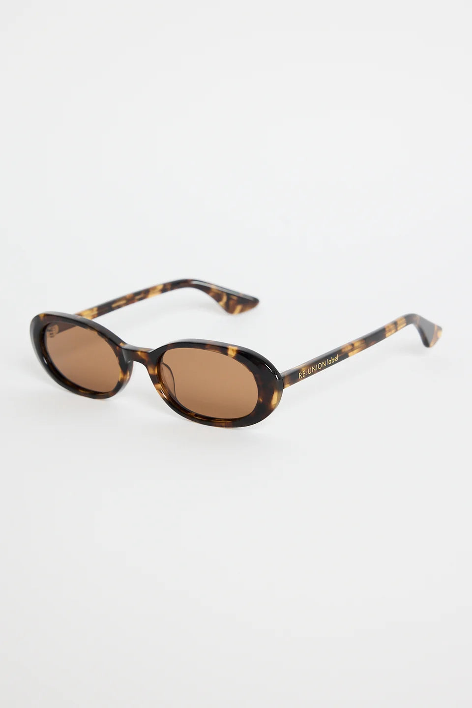 The Sydney Tort Narrow Oval Sunglasses bring a retro-cool finish to your everyday style. With a slim oval silhouette and a classic tortoiseshell frame, they strike that perfect mix of playful and polished. Warm brown lenses give them an easy, laidback feel that works with everything from casual tees to sun-ready dresses.

A chic little statement that instantly elevates your look

- Recycled Acetate

- UV Protection Category 3