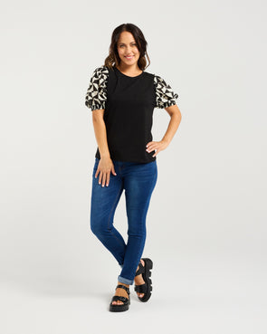 Black body with contrasting abstract puff sleeves

Voluminous short sleeves for added shape

Statement style that’s easy to dress up or down

Soft, comfortable fabric with a flattering fit

Body: 95% Cotton 5% Spandex
Sleeve: 100% Cotton