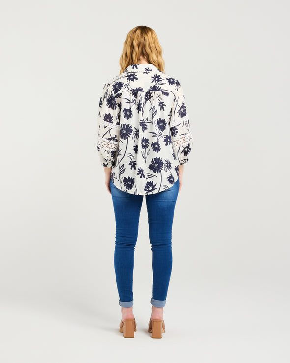 Classic button-down shirt design

Collar neckline with scalloped trim

3/4 puff sleeves with elasticated cuffs

Delicate lace inserts for a feminine touch

Timeless and versatile style

100% Cotton