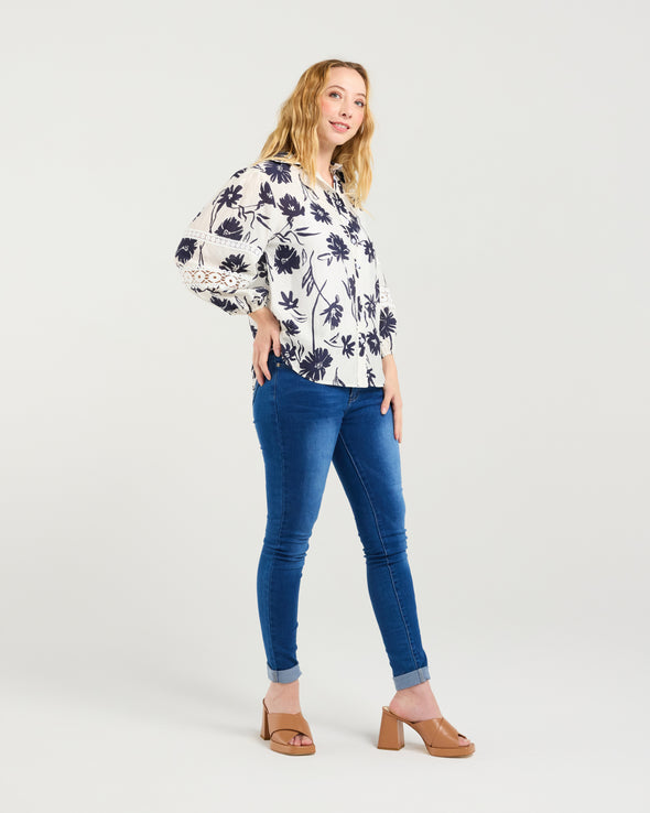 Classic button-down shirt design

Collar neckline with scalloped trim

3/4 puff sleeves with elasticated cuffs

Delicate lace inserts for a feminine touch

Timeless and versatile style

100% Cotton
