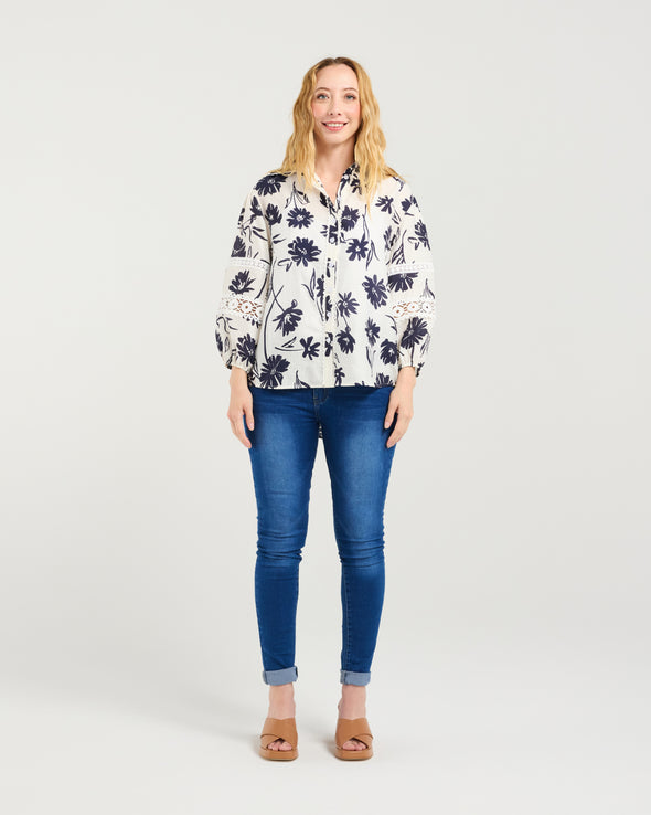 Classic button-down shirt design

Collar neckline with scalloped trim

3/4 puff sleeves with elasticated cuffs

Delicate lace inserts for a feminine touch

Timeless and versatile style

100% Cotton
