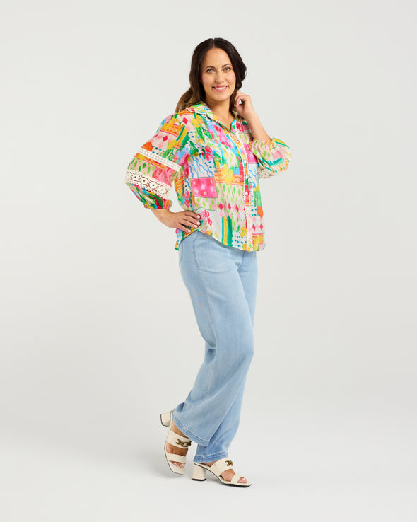 Bright Radiant print for a bold, modern look

Classic button-down style with collar neckline

3/4 puff sleeves with elasticated cuffs

Lace inserts and scalloped trim for feminine detail

Versatile shirt for work, weekends, or events

70% Rayon 30% Nylon