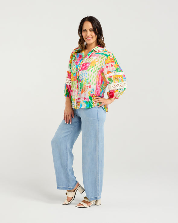 Bright Radiant print for a bold, modern look

Classic button-down style with collar neckline

3/4 puff sleeves with elasticated cuffs

Lace inserts and scalloped trim for feminine detail

Versatile shirt for work, weekends, or events

70% Rayon 30% Nylon
