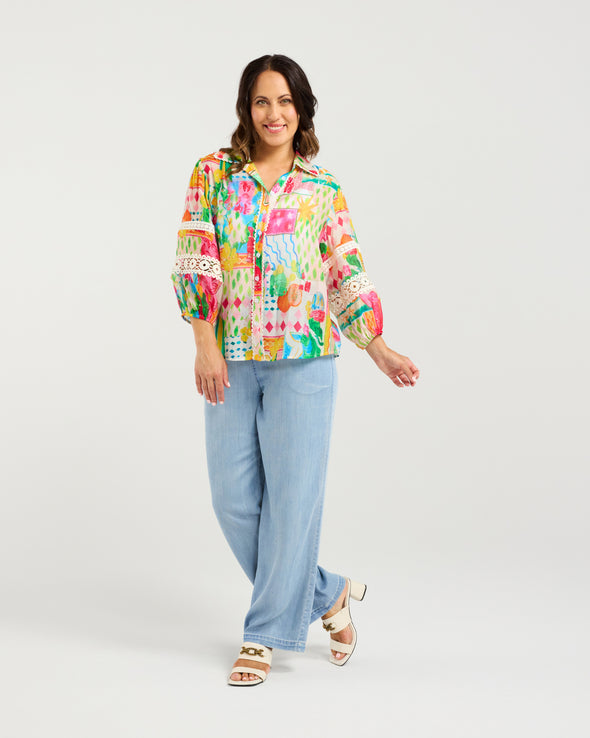 Bright Radiant print for a bold, modern look

Classic button-down style with collar neckline

3/4 puff sleeves with elasticated cuffs

Lace inserts and scalloped trim for feminine detail

Versatile shirt for work, weekends, or events

70% Rayon 30% Nylon
