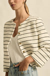 Crafted in 100% cotton

Fully lined in soft stretch fabric for all day comfort

Summer-weight boucle texture with a timeless feel

Round neckline and cropped silhouette for styling versatility

Brushed brass domed buttons for a refined accent

Rounded off front pockets that blend seamlessly into the boucle

Classic tailoring influence with a modern edge