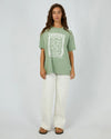The Costiera Relaxed Tee in sage green brings easygoing style with a comfy, breathable fit that feels like a gentle breeze all day long. Its bold white hand-drawn print adds an artsy twist to a calm, neutral shade. Pair it with your fave high-waisted jeans or sharp shorts for a look that’s effortlessly cool—perfect for anything from coffee runs to evening hangs.