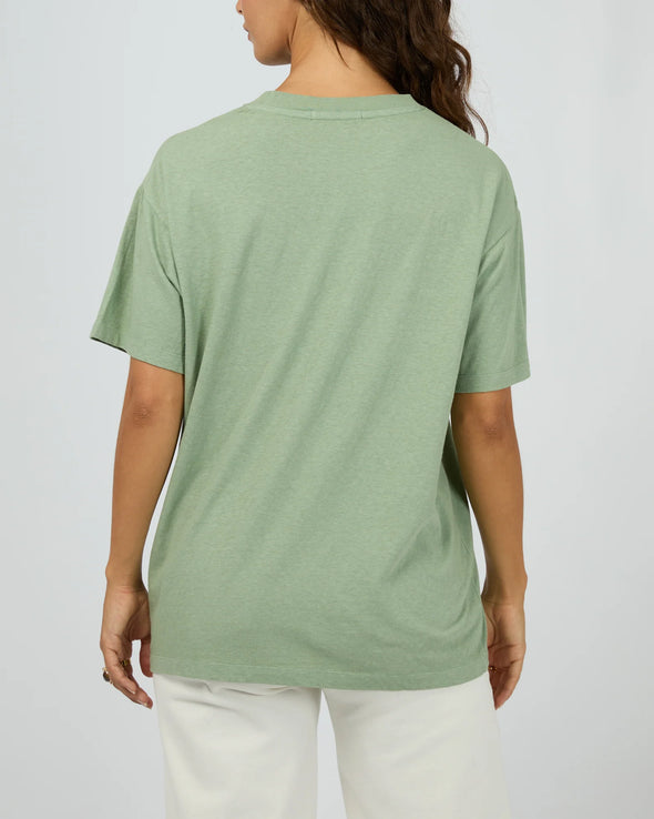 The Costiera Relaxed Tee in sage green brings easygoing style with a comfy, breathable fit that feels like a gentle breeze all day long. Its bold white hand-drawn print adds an artsy twist to a calm, neutral shade. Pair it with your fave high-waisted jeans or sharp shorts for a look that’s effortlessly cool—perfect for anything from coffee runs to evening hangs.
