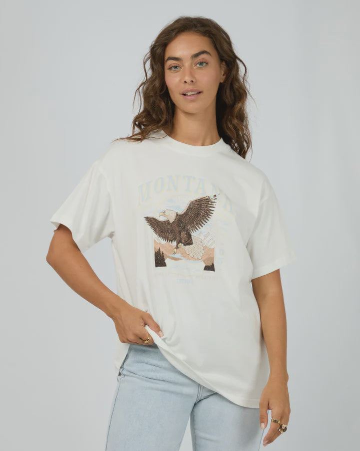 Stay cool and comfy in the All About Eve Montana Relaxed Tee, made from 100% soft cotton. With its easygoing fit and eye-catching graphic print, this tee brings laid-back vibes with a stylish twist—perfect for those days when you want to look effortlessly cool while keeping it casual.