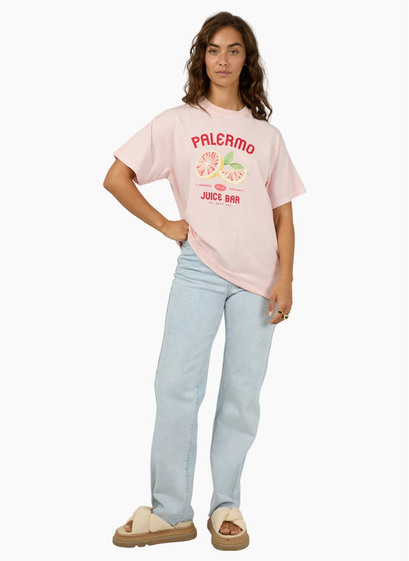 The Palermo Relaxed Tee adds a bold splash of fun to your wardrobe with its vibrant pink base, eye-catching red text, and a playful grapefruit graphic that brings a fresh, zesty vibe. Crafted from soft 100% cotton with a relaxed fit and crew neckline, it’s perfect for effortless everyday style. Pair it with your favorite denim or wide-leg pants for a standout, comfortable look that’s ready to brighten any day.