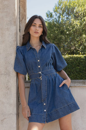 - Statement puff sleeves for a bold yet feminine look
- Button-down front for a classic touch
- Adjustable waist belt for a flattering, cinched silhouette
- Crafted from soft indigo denim with contrast stitching
- Fabric Composition - 80% Cotton 20% Polyester