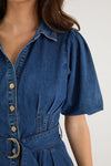 - Statement puff sleeves for a bold yet feminine look
- Button-down front for a classic touch
- Adjustable waist belt for a flattering, cinched silhouette
- Crafted from soft indigo denim with contrast stitching
- Fabric Composition - 80% Cotton 20% Polyester