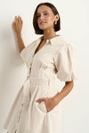 - Statement puff sleeves for a bold yet feminine look
- Button-down front for a classic touch
- Adjustable waist belt for a flattering, cinched silhouette
- Crafted from soft ecru denim with contrast stitching