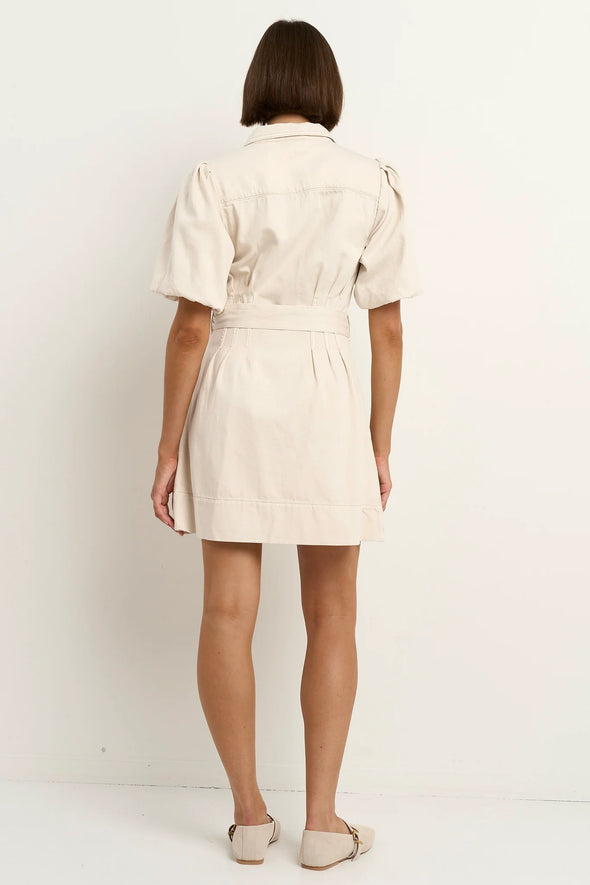 - Statement puff sleeves for a bold yet feminine look
- Button-down front for a classic touch
- Adjustable waist belt for a flattering, cinched silhouette
- Crafted from soft ecru denim with contrast stitching