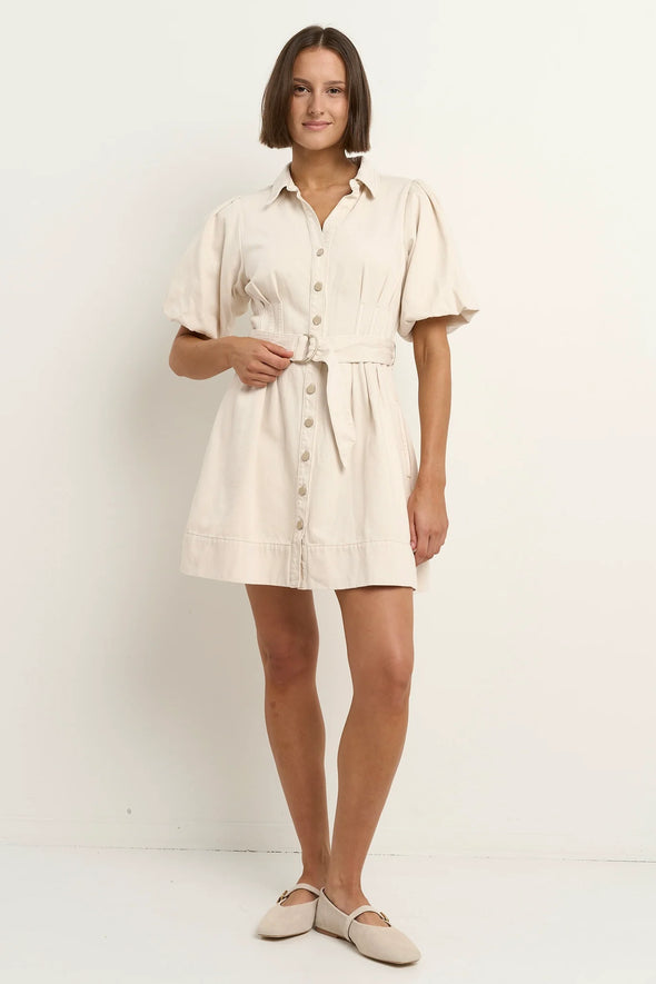 - Statement puff sleeves for a bold yet feminine look
- Button-down front for a classic touch
- Adjustable waist belt for a flattering, cinched silhouette
- Crafted from soft ecru denim with contrast stitching