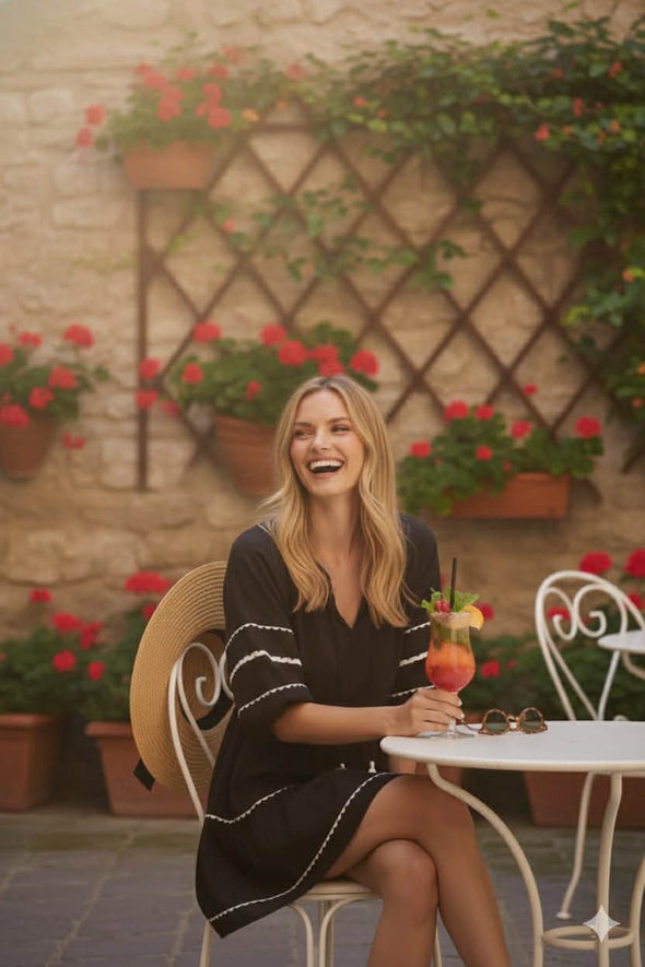 • Made from breathable 100% cotton
• Natural fibre for lightweight, airy comfort
• Tiered silhouette adds soft volume and flow
• Relaxed sleeves for casual ease
• Plain black design elevated with subtle trim detail