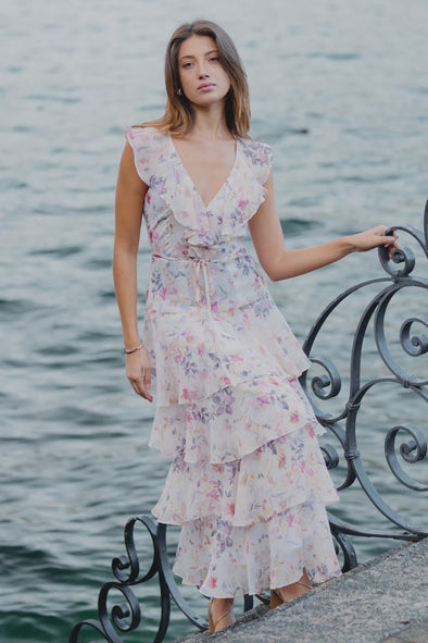 Get ready to turn heads at every event with our Everly Ivory Bouquet Maxi Dress! The flowing tiered design and flutter sleeves add a touch of whimsy to this feminine floral dress. Easily adjust the fit with the tie at the waist. Perfect for any occasion, this dress is sure to bring in compliments.
