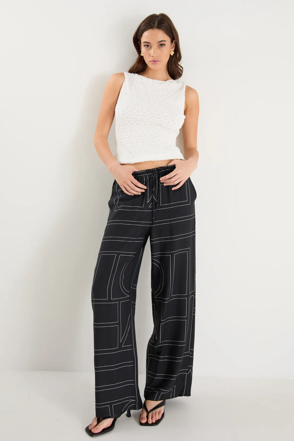 The Clever Black Lines Drawcord Wide Leg Pants offer a relaxed yet refined look with their subtle line print and wide-leg silhouette. Featuring a high-rise fit and adjustable drawcord waist, these trousers provide a flattering and customizable shape. Crafted from a lightweight fabric blend, they ensure breathable comfort from daytime meetings to evening outings.