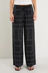 The Clever Black Lines Drawcord Wide Leg Pants offer a relaxed yet refined look with their subtle line print and wide-leg silhouette. Featuring a high-rise fit and adjustable drawcord waist, these trousers provide a flattering and customizable shape. Crafted from a lightweight fabric blend, they ensure breathable comfort from daytime meetings to evening outings.