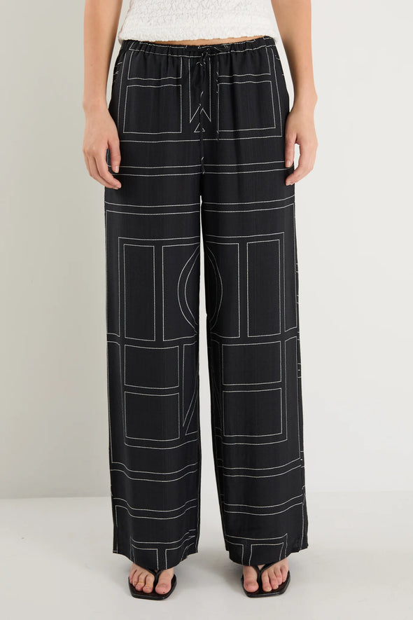 The Clever Black Lines Drawcord Wide Leg Pants offer a relaxed yet refined look with their subtle line print and wide-leg silhouette. Featuring a high-rise fit and adjustable drawcord waist, these trousers provide a flattering and customizable shape. Crafted from a lightweight fabric blend, they ensure breathable comfort from daytime meetings to evening outings.