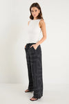 The Clever Black Lines Drawcord Wide Leg Pants offer a relaxed yet refined look with their subtle line print and wide-leg silhouette. Featuring a high-rise fit and adjustable drawcord waist, these trousers provide a flattering and customizable shape. Crafted from a lightweight fabric blend, they ensure breathable comfort from daytime meetings to evening outings.