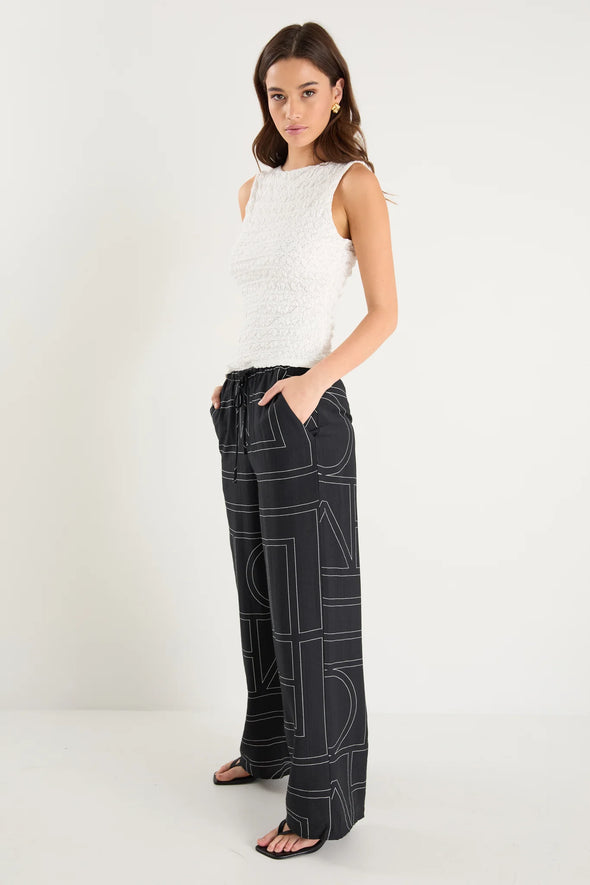 The Clever Black Lines Drawcord Wide Leg Pants offer a relaxed yet refined look with their subtle line print and wide-leg silhouette. Featuring a high-rise fit and adjustable drawcord waist, these trousers provide a flattering and customizable shape. Crafted from a lightweight fabric blend, they ensure breathable comfort from daytime meetings to evening outings.