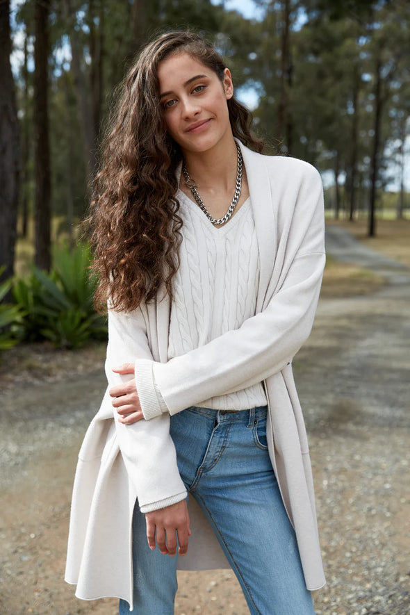 Embrace the style and softness of the Alawa Cable Knit, set to be a winter favourite. With its V-neck, woven cable design, and raw edge, this knit secures its spot in your seasonal wardrobe. Versatile and chic, it pairs seamlessly with denim or a maxi skirt with a scarf, offering comfort and a touch of fashionable flair for the colder days ahead.