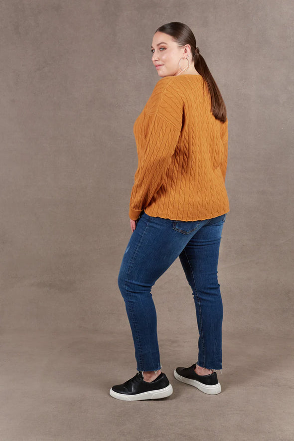 Embrace the style and softness of the Alawa Cable Knit, set to be a winter favourite. With its V-neck, woven cable design, and raw edge, this knit secures its spot in your seasonal wardrobe. Versatile and chic, it pairs seamlessly with denim or a maxi skirt with a scarf, offering comfort and a touch of fashionable flair for the colder days ahead.