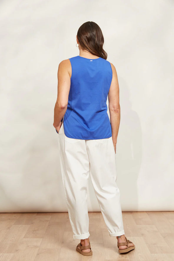 The Verano Tank is all about comfort and versatility, crafted with soft and stretchy cotton. Its sleeveless design and relaxed silhouette make it ideal for standalone wear or layering to elevate an outfit. With its adaptable style, the Verano Tank pairs effortlessly with jeans for a casual vibe or tucked into a maxi skirt or wide-leg trousers for a more polished look.