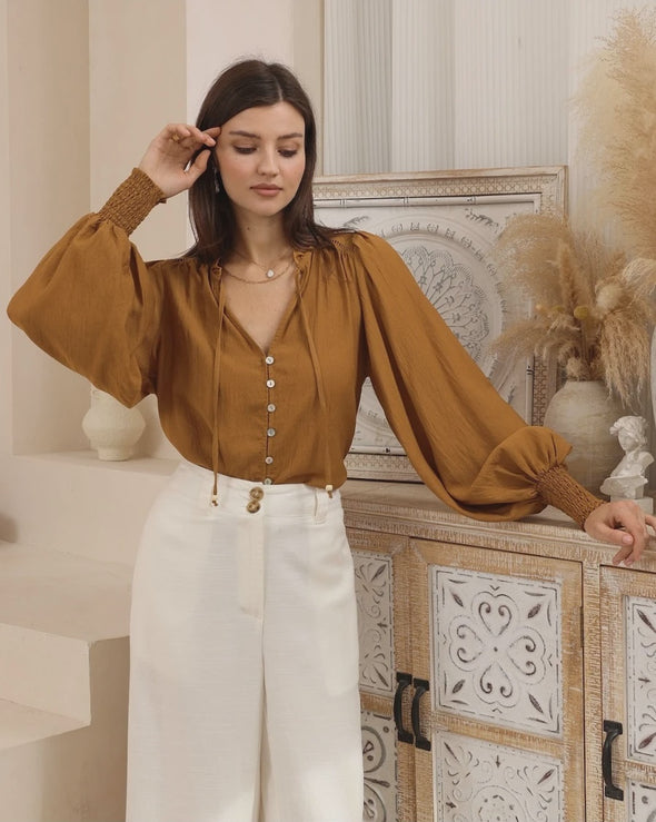 Bringing a warm glow to your everyday style with the rich bronze-earthy colour-way. Featuring a softly draped shape and V neckline - It is a simple to style staple.