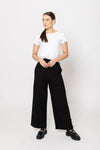 Meet your new go-to: the Billie The Label Essential Wide Leg Pants in classic black. With a sleek flat front waist and comfy elastic back, they fit like a dream. Two handy pockets add practicality to the style, making them perfect for everyday adventures. Crafted from a soft blend of 65% viscose and 35% nylon, these pants offer both comfort and flow with every step.&nbsp;